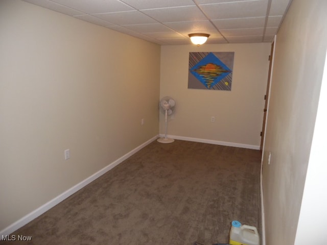 interior space with a drop ceiling and dark carpet