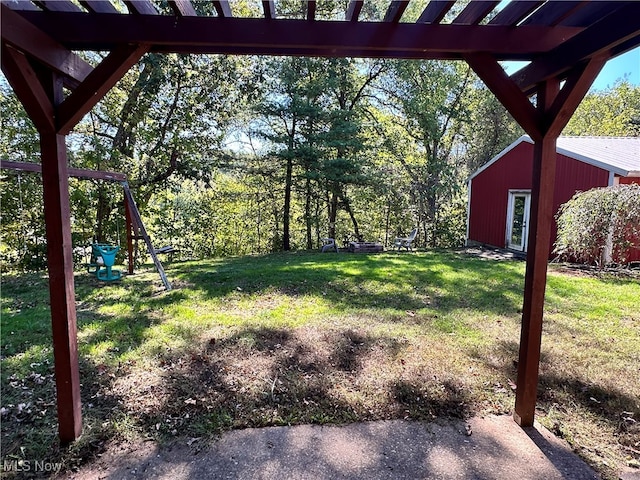 view of yard with a pergola and a playground