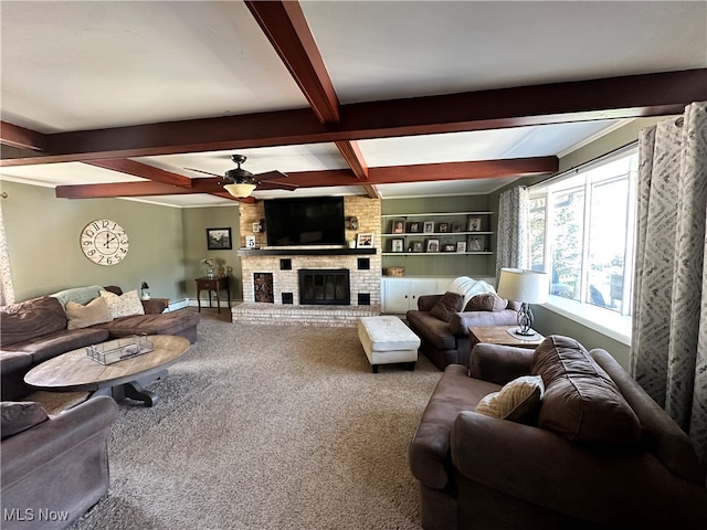 living room featuring a fireplace, beamed ceiling, ceiling fan, built in features, and carpet