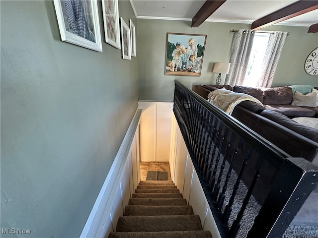 stairway featuring beamed ceiling and crown molding