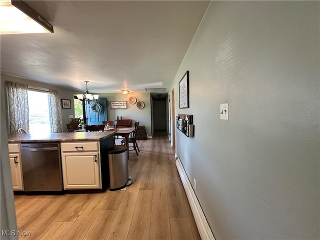 kitchen featuring a notable chandelier, light wood-type flooring, dishwasher, and hanging light fixtures