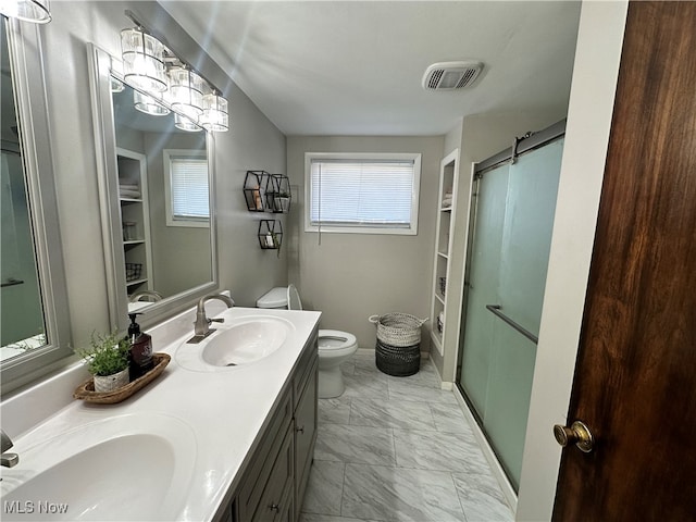 bathroom featuring walk in shower, vanity, and toilet