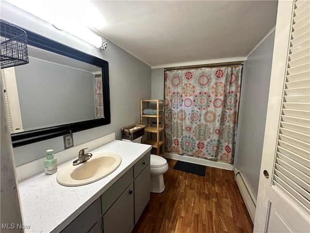 bathroom with vanity, toilet, baseboard heating, walk in shower, and hardwood / wood-style floors