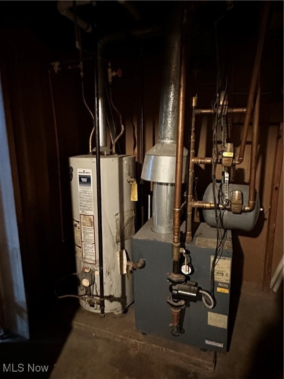 utility room featuring water heater