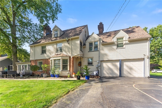 view of front of home with a front lawn and a garage