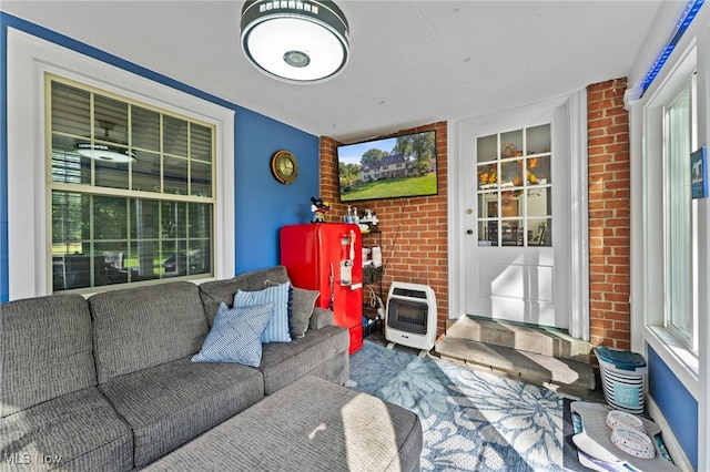 living room with brick wall and heating unit