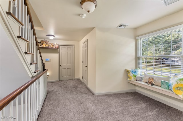 corridor with light colored carpet