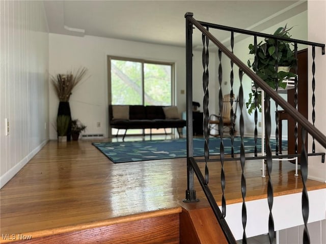 stairs with hardwood / wood-style flooring and a baseboard radiator