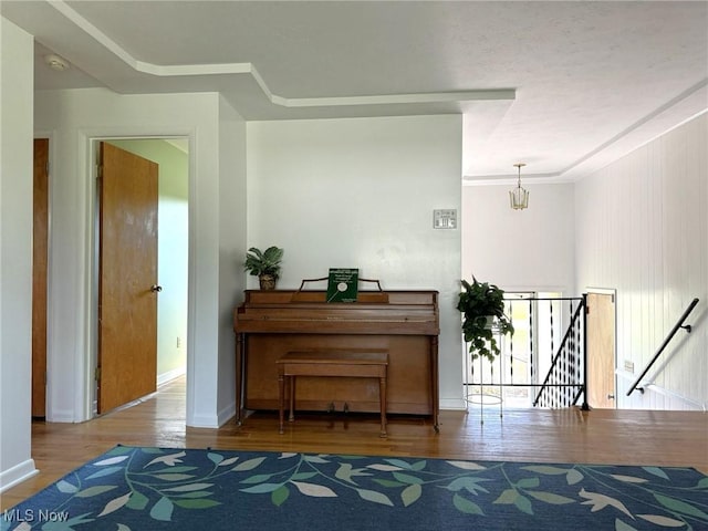 miscellaneous room with crown molding and wood-type flooring