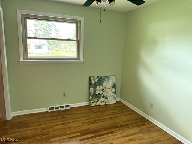 empty room featuring ceiling fan and wood-type flooring