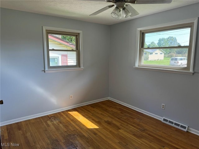 empty room featuring ceiling fan and dark hardwood / wood-style flooring