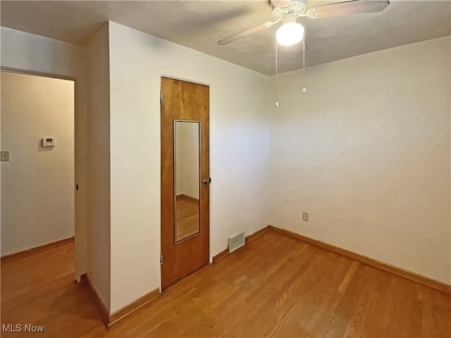 spare room with light hardwood / wood-style flooring and ceiling fan