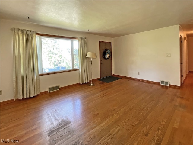 unfurnished living room with hardwood / wood-style flooring