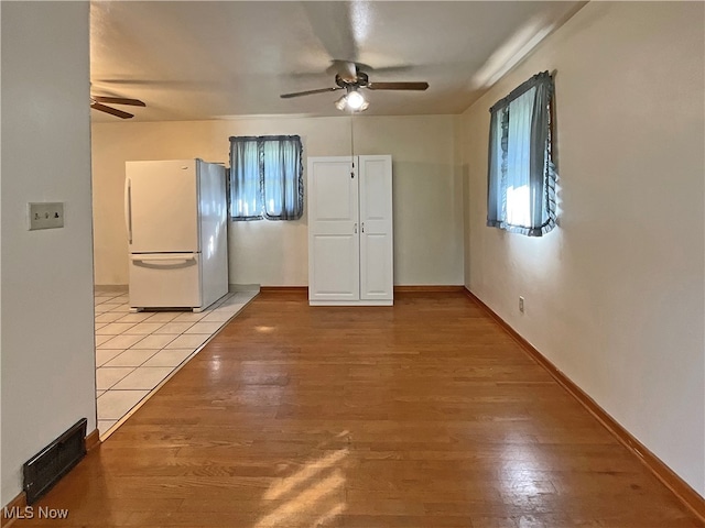 interior space with ceiling fan and light hardwood / wood-style flooring