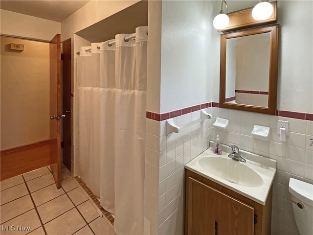 bathroom featuring tile walls, tile patterned floors, vanity, toilet, and a shower with curtain