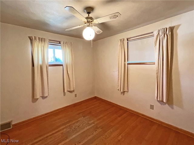 empty room featuring ceiling fan and hardwood / wood-style flooring