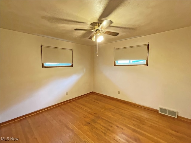 spare room featuring ceiling fan and hardwood / wood-style floors