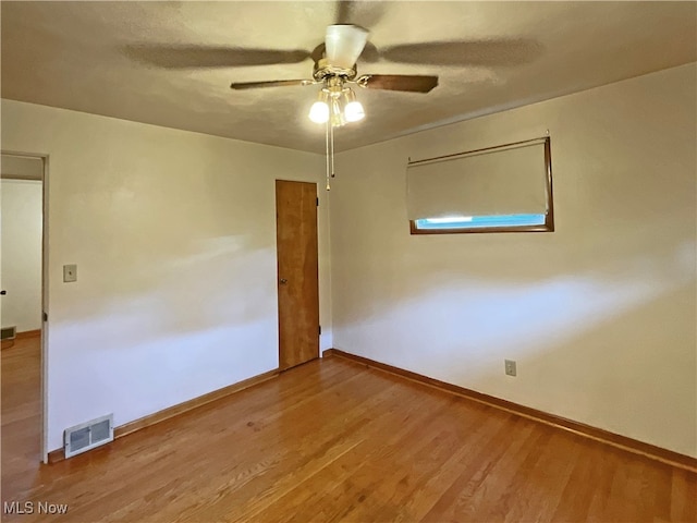 spare room with wood-type flooring and ceiling fan