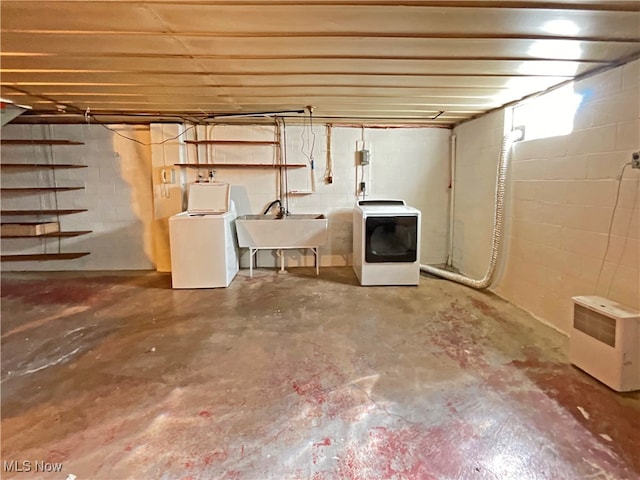 basement with sink and washing machine and clothes dryer