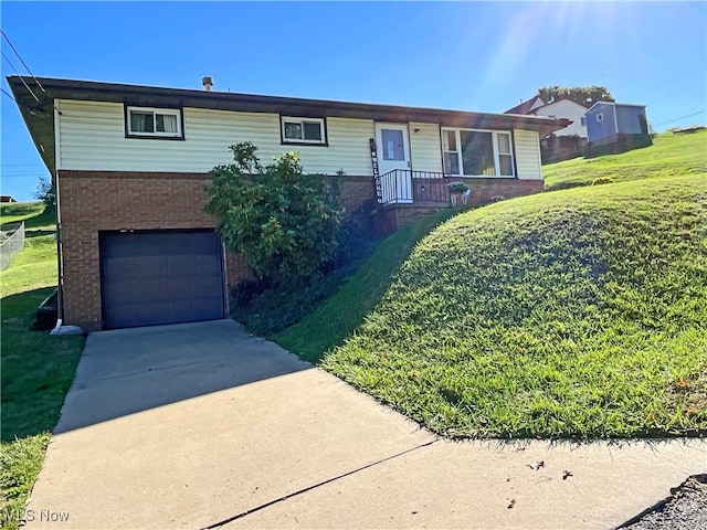 view of front of house featuring a garage and a front lawn