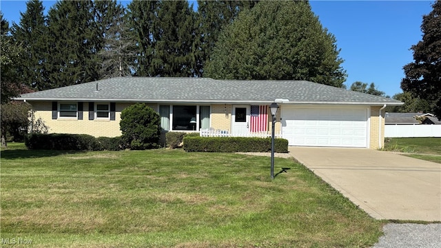 single story home featuring a front yard and a garage