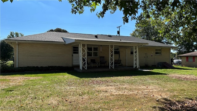 rear view of house with a yard