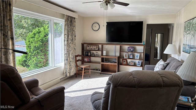 carpeted living room featuring ceiling fan