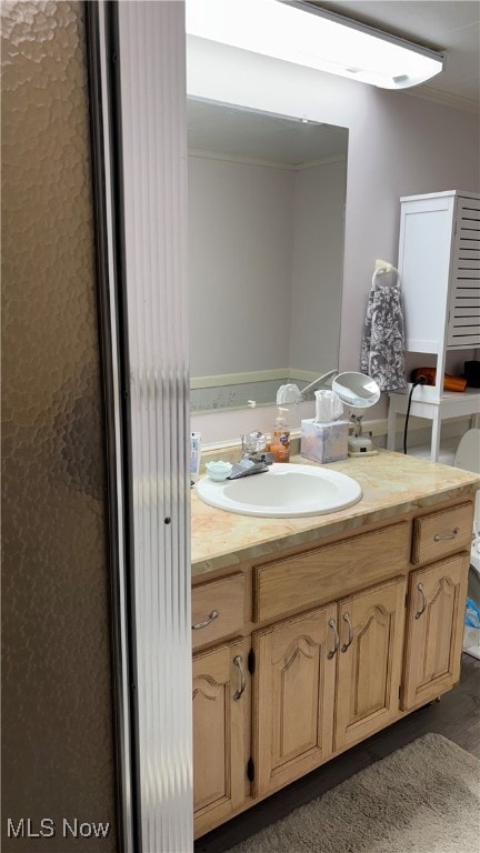 bathroom with vanity and crown molding