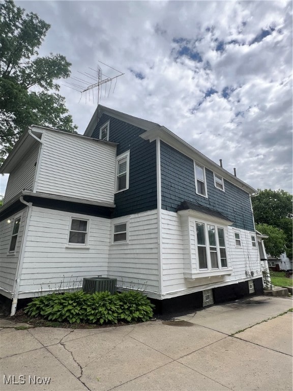 view of property exterior with central AC