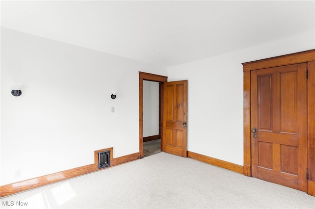 spare room with light colored carpet