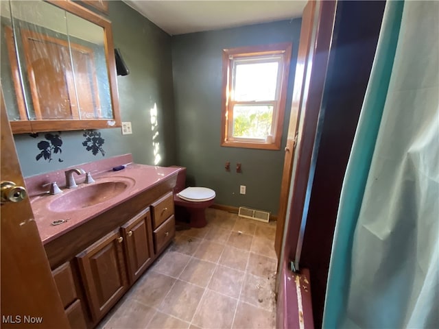 bathroom featuring vanity and toilet