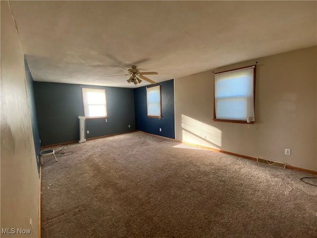 carpeted spare room with ceiling fan and a textured ceiling