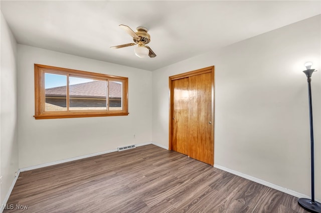 unfurnished bedroom with wood-type flooring and ceiling fan