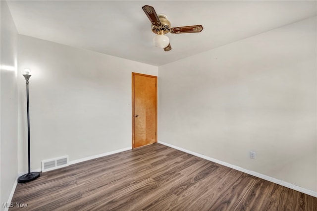 unfurnished room with ceiling fan and dark wood-type flooring