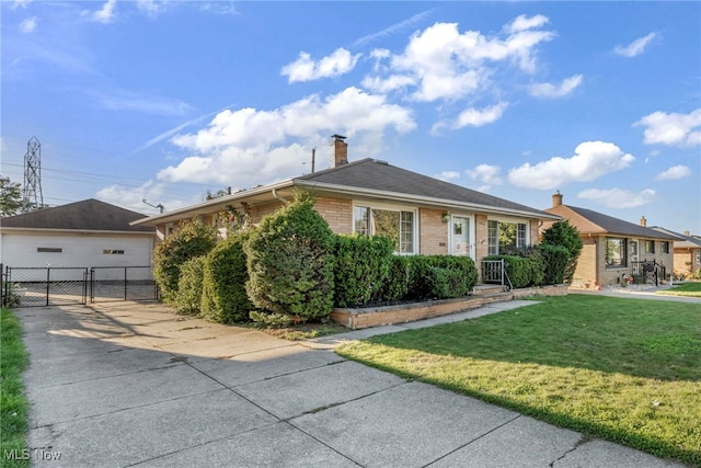 ranch-style house featuring a garage and a front lawn