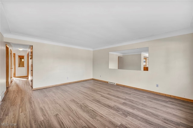 spare room featuring light wood-type flooring