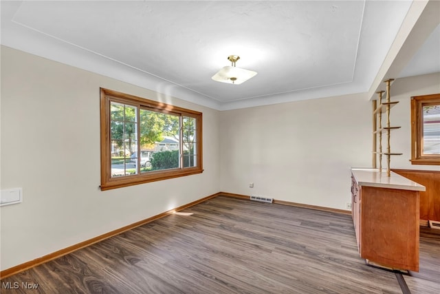 spare room featuring dark hardwood / wood-style flooring