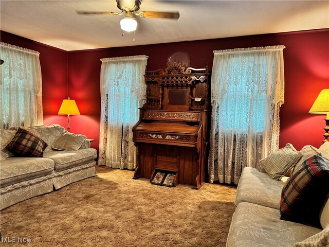 carpeted living room featuring ceiling fan