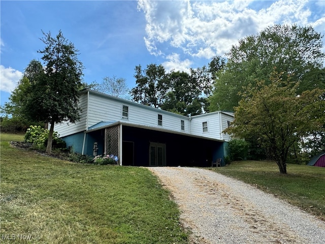 view of front of property with a front lawn and a carport