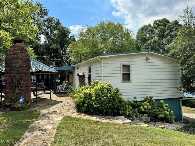 exterior space featuring a patio area, a gazebo, and a yard