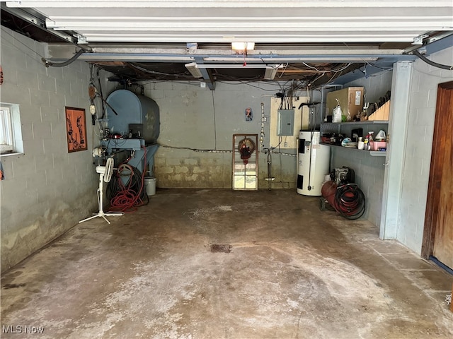 garage featuring water heater and electric panel