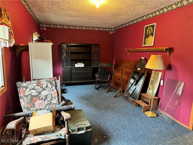 living area with a textured ceiling and carpet flooring