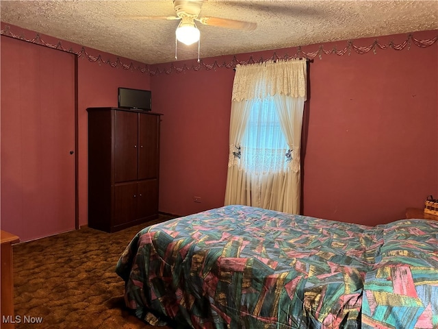 carpeted bedroom with a textured ceiling and ceiling fan