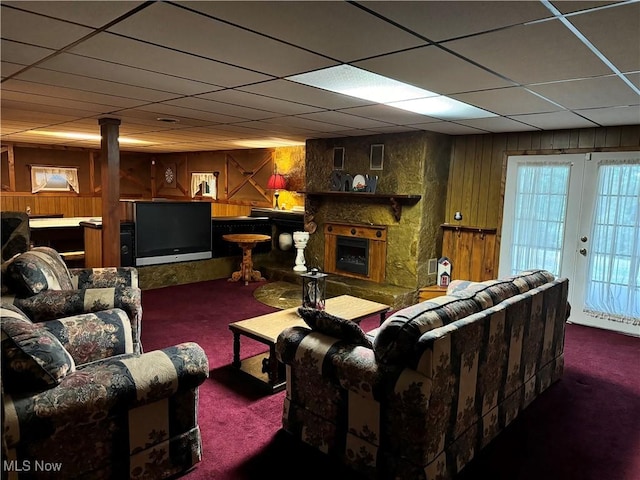 70571 Pine Hollow Rd, Bridgeport, OH 43912 - living area featuring carpet, wood walls, a fireplace, and a paneled ceiling