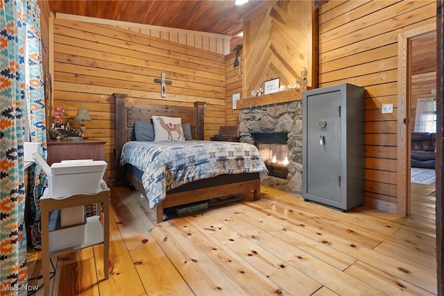 bedroom featuring wood ceiling, lofted ceiling, wood walls, and hardwood / wood-style flooring