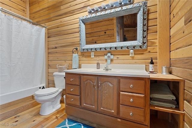 full bathroom with shower / bath combination with curtain, wooden walls, vanity, and toilet