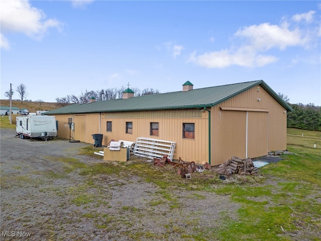 view of home's exterior featuring an outbuilding