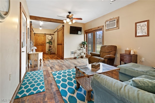 living room with a barn door, beamed ceiling, ceiling fan, a wall unit AC, and hardwood / wood-style floors