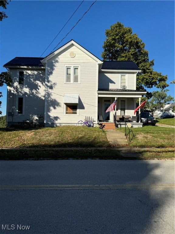 view of front property featuring a front lawn and covered porch