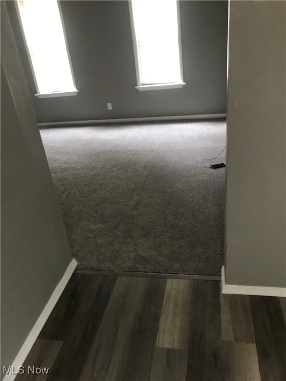 unfurnished room featuring dark wood-type flooring